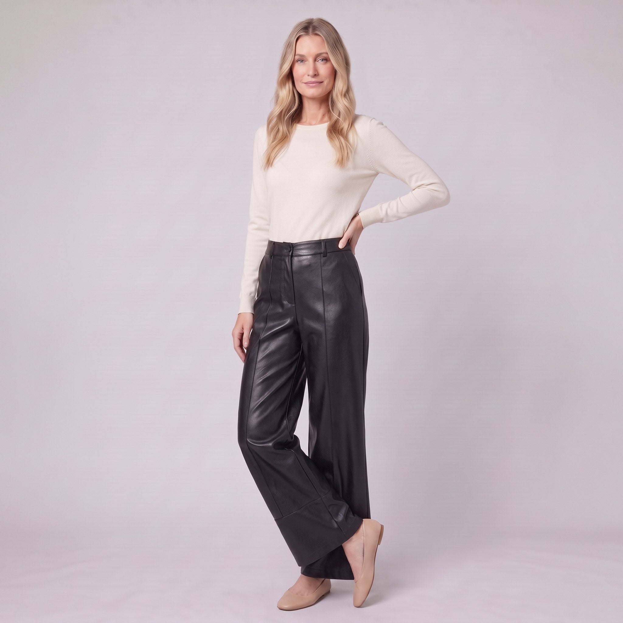 Helka faux leather wide leg trousers in black, three-quarter view showing the leather sheen