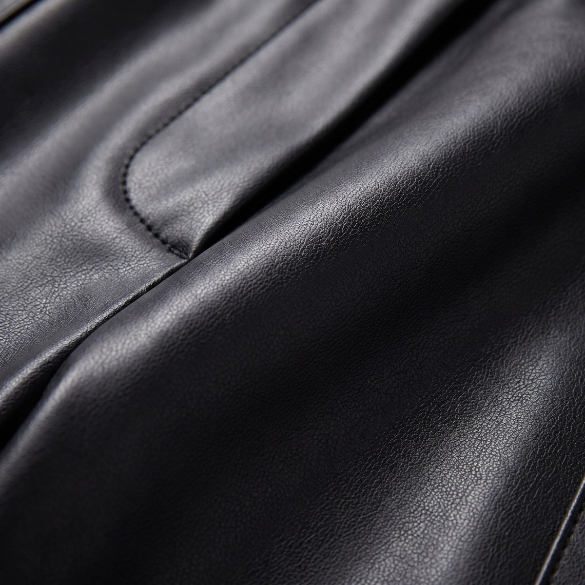 Helka faux leather trousers fabric detail, smooth glossy PU close-up