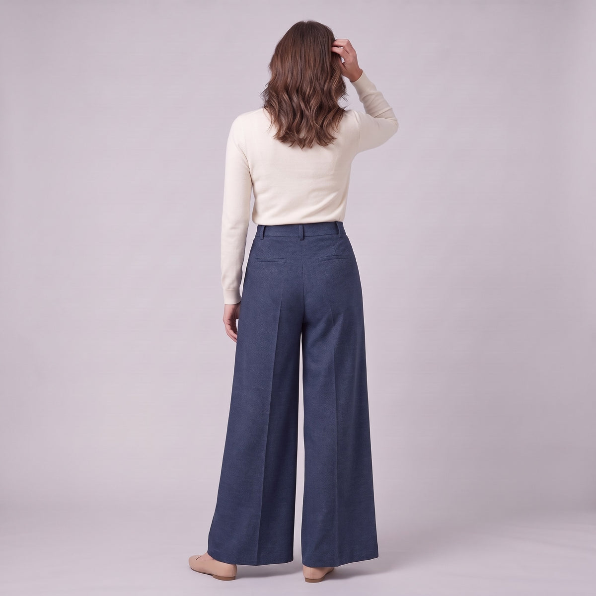 Hesper pleated wide leg trousers in navy blue, back view on model