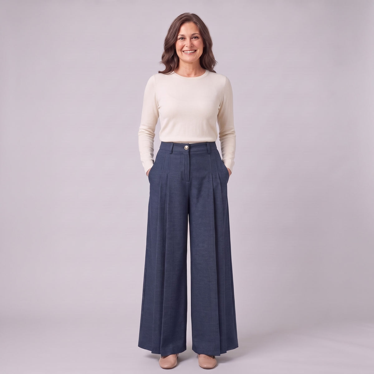 Hesper pleated wide leg trousers in navy blue, full-length view with hands in the pockets