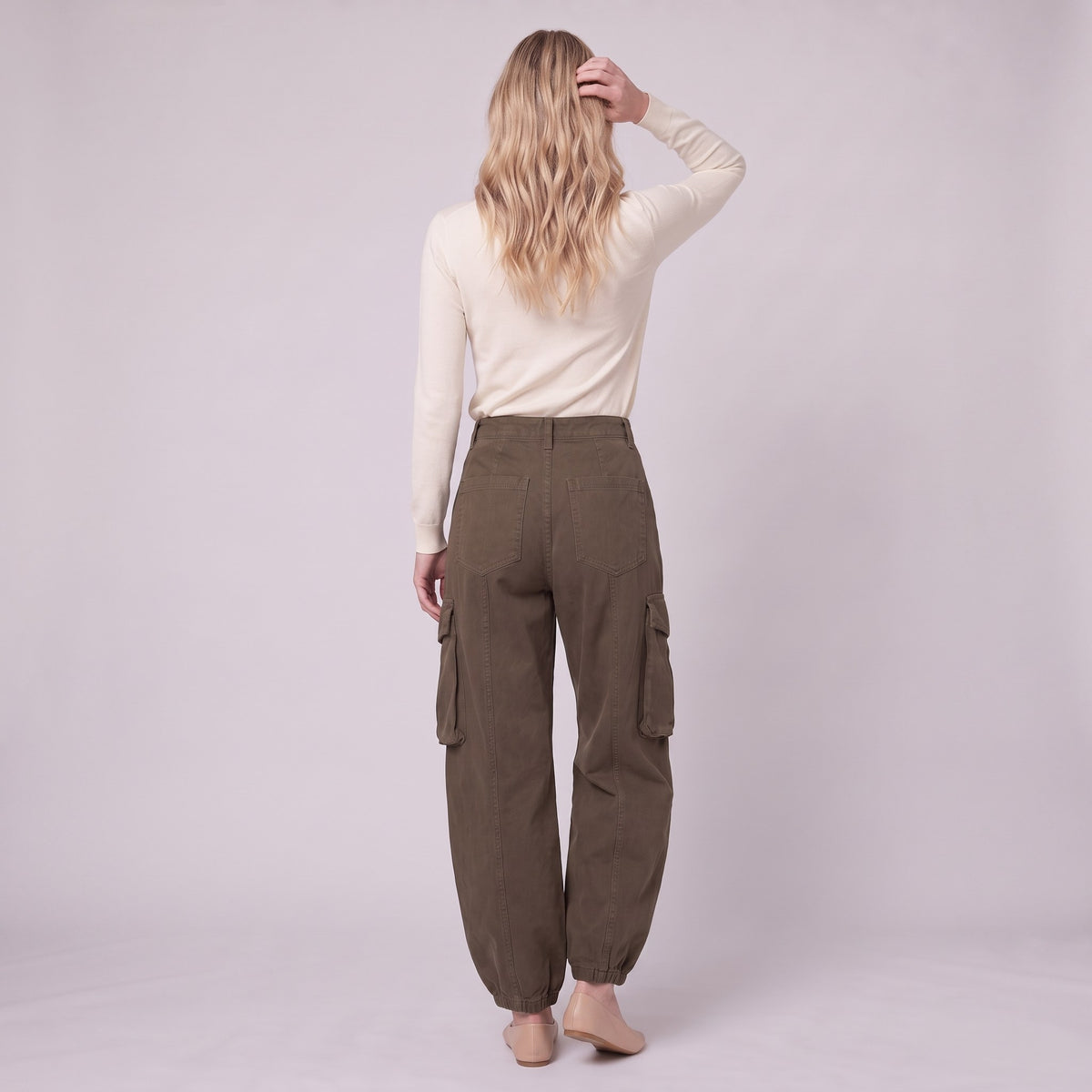 Inara baggy cargo trousers in dark olive brown, back view on model