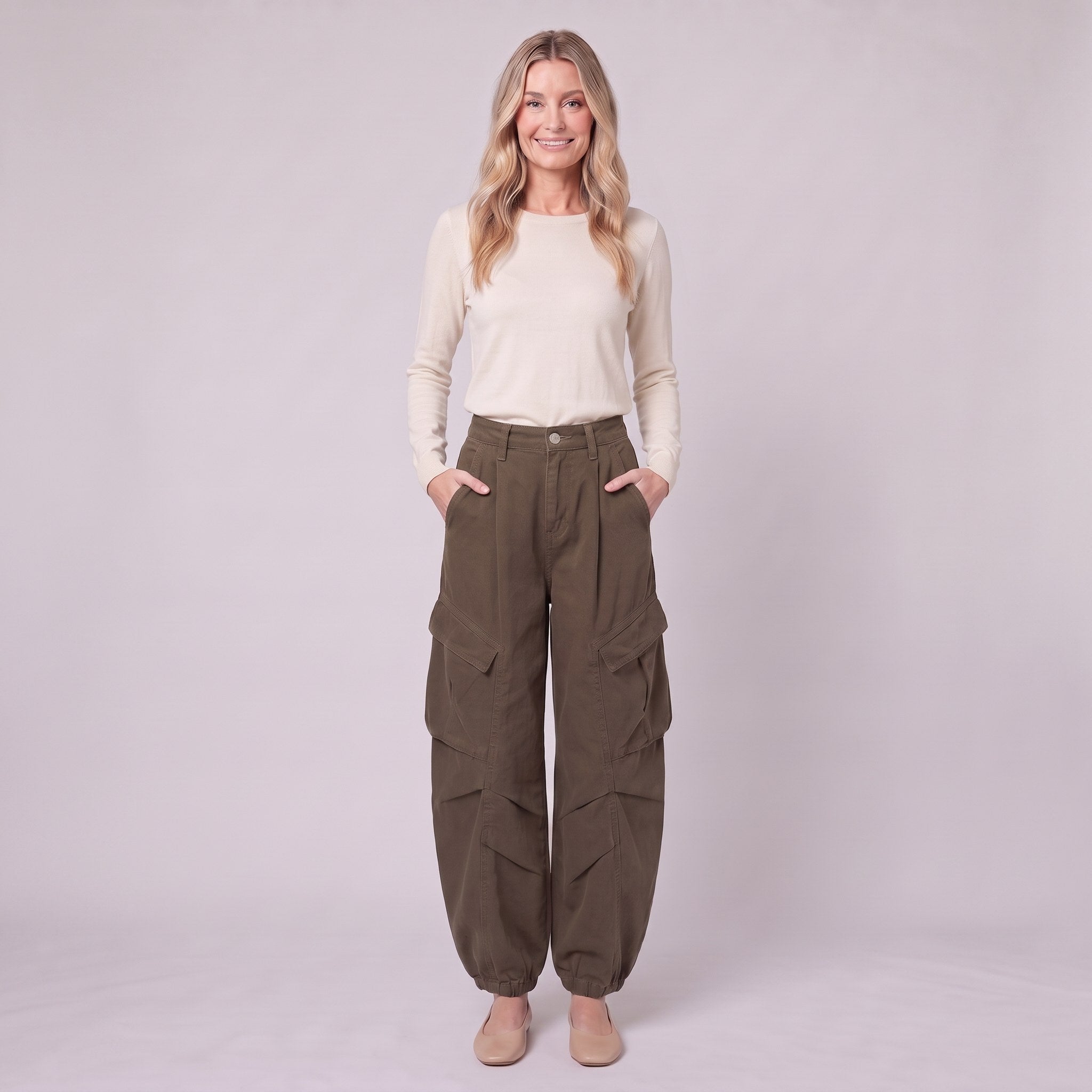 Inara baggy cargo trousers in dark olive brown, full-length view with hands in the pockets
