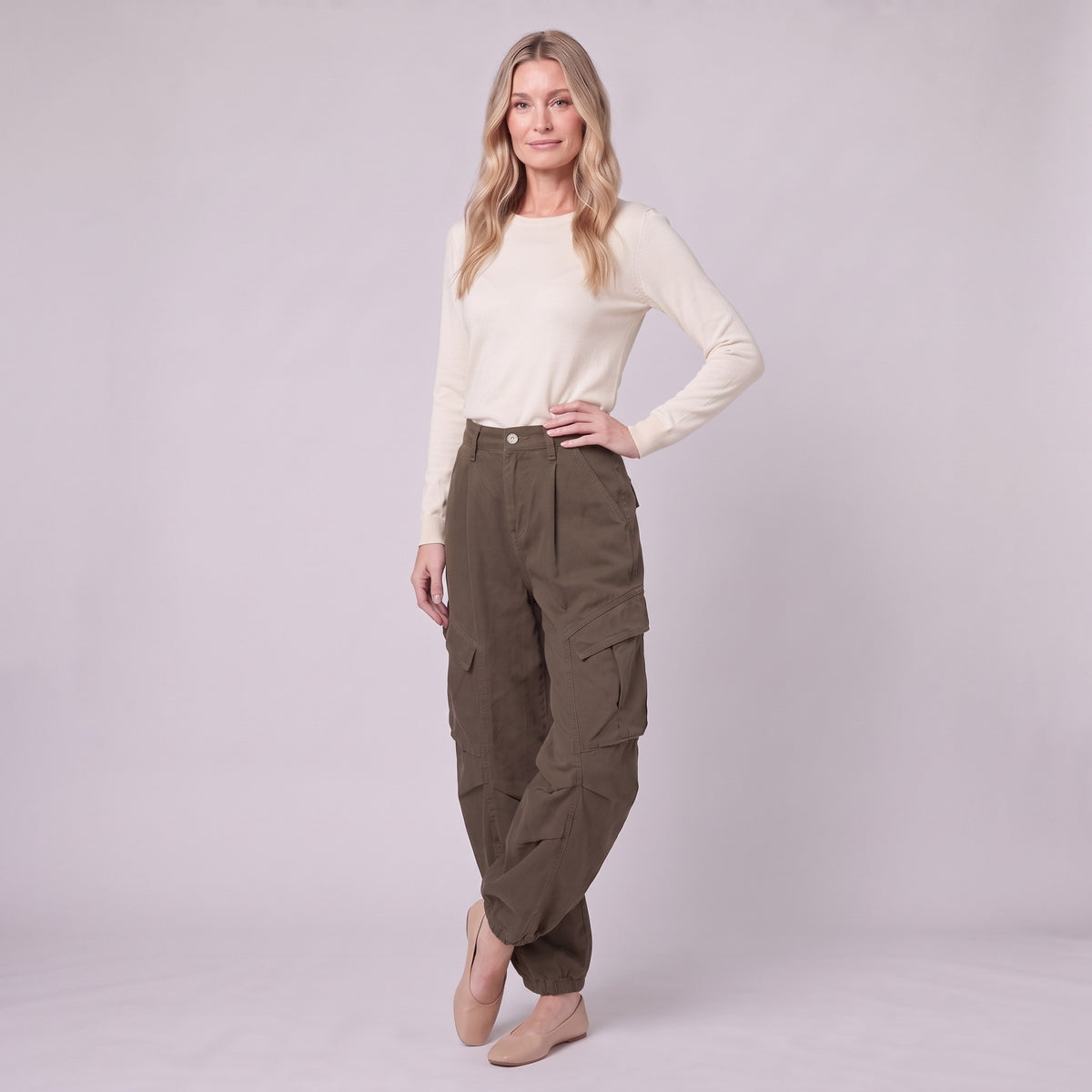 Inara baggy cargo trousers in dark olive brown, three-quarter view showing the cargo pockets