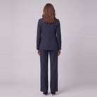 Iris navy pinstripe suit seen from behind, showing the blazer back and trouser drape