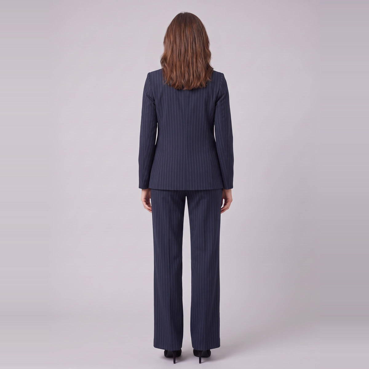 Iris navy pinstripe suit seen from behind, showing the blazer back and trouser drape