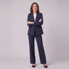 Iris navy pinstripe suit with arms crossed, standing view