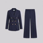 Iris navy pinstripe blazer and trousers shown without a model on a light grey background