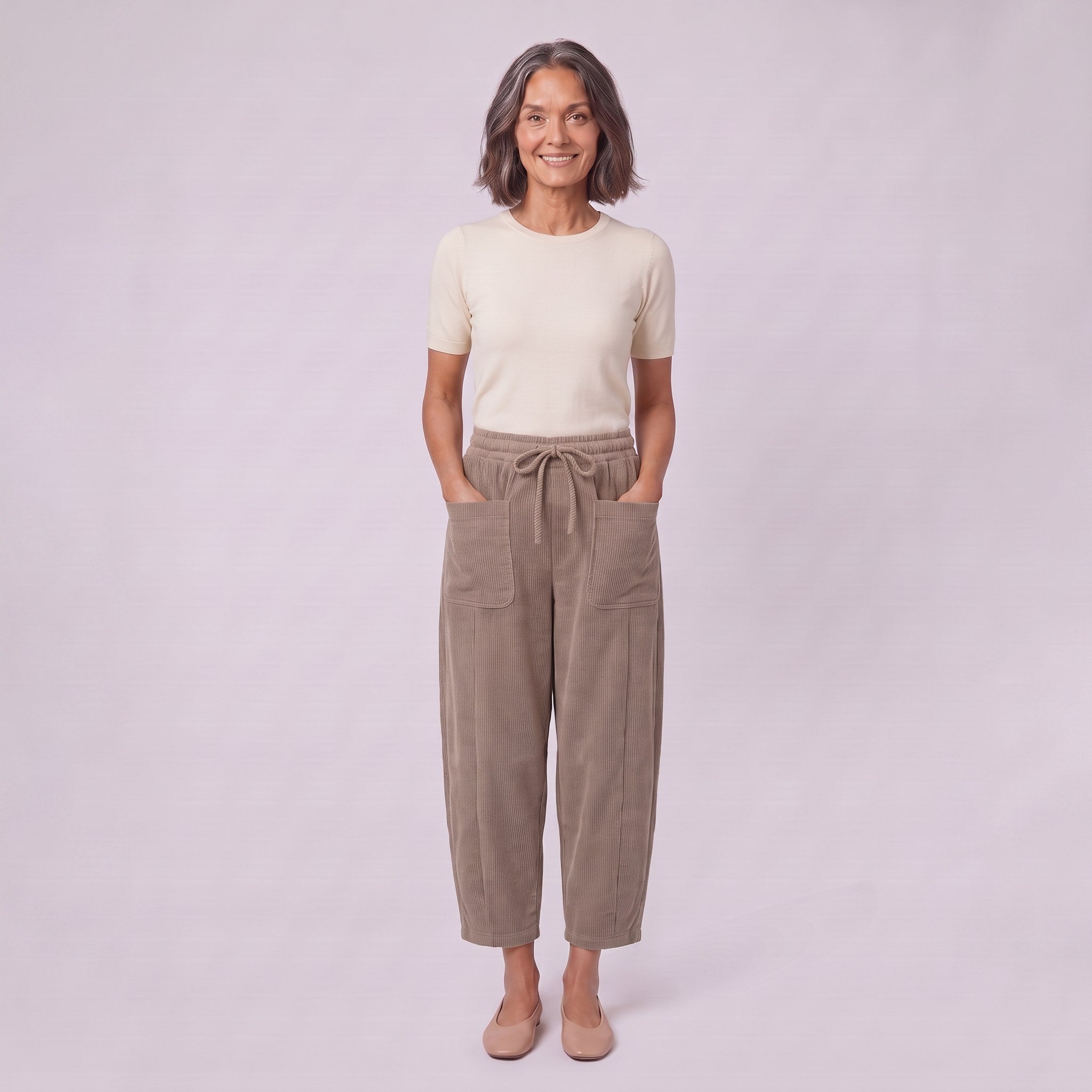 Kerensa barrel leg corduroy trousers in khaki taupe, full-length view with hands in patch pockets