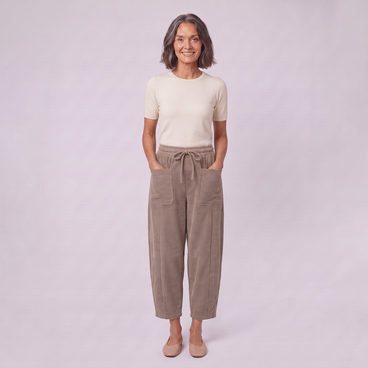 Kerensa barrel leg corduroy trousers in khaki taupe, full-length view with hands in patch pockets