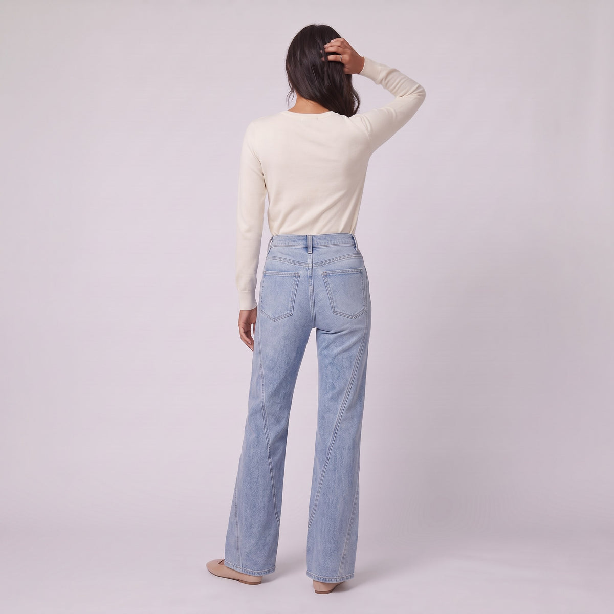 Lavinia high rise flared jeans in light wash blue denim, back view on model