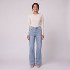 Lavinia high rise flared jeans in light wash blue denim, front view on model