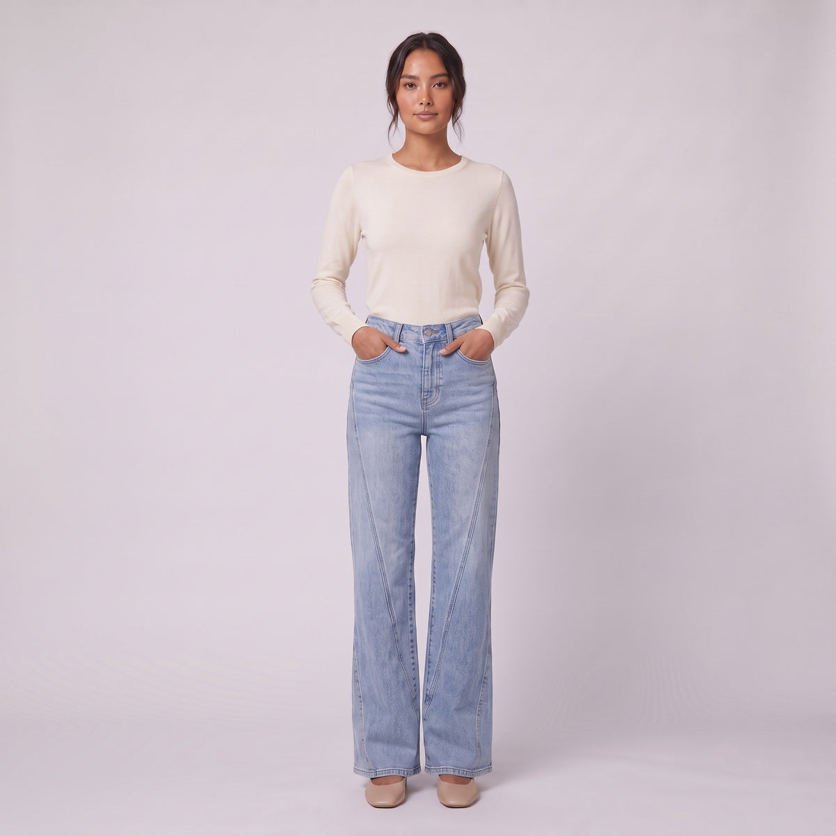 Lavinia high rise flared jeans in light wash blue denim, full-length view with hands in the pockets