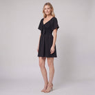 Black mini dress with a V-neck and bow tie detail, view 2