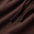 Mairead wide leg trousers fabric detail, soft twill weave and drawstring close-up in chocolate brown