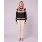 Nieve pumpkin fair isle sweater in black, front view on model with cream trousers