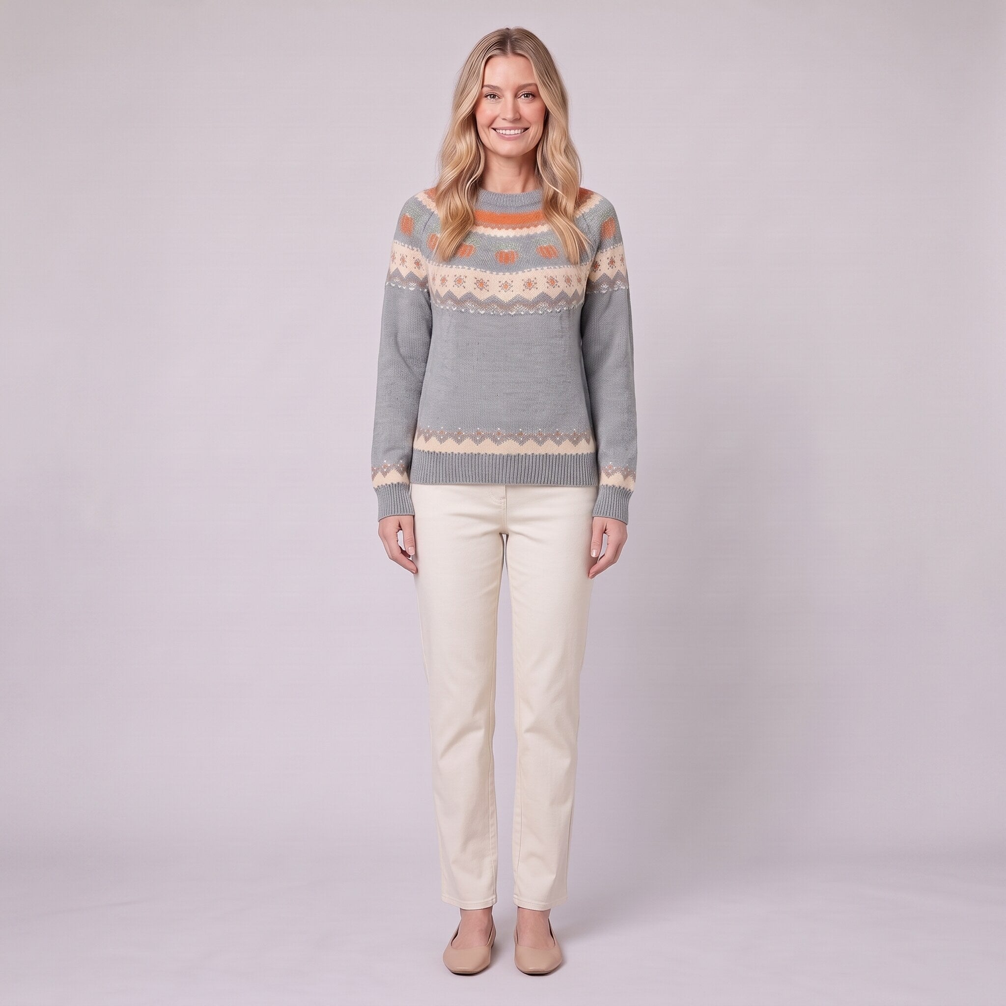 Nieve pumpkin fair isle sweater in grey, front view on model with cream trousers