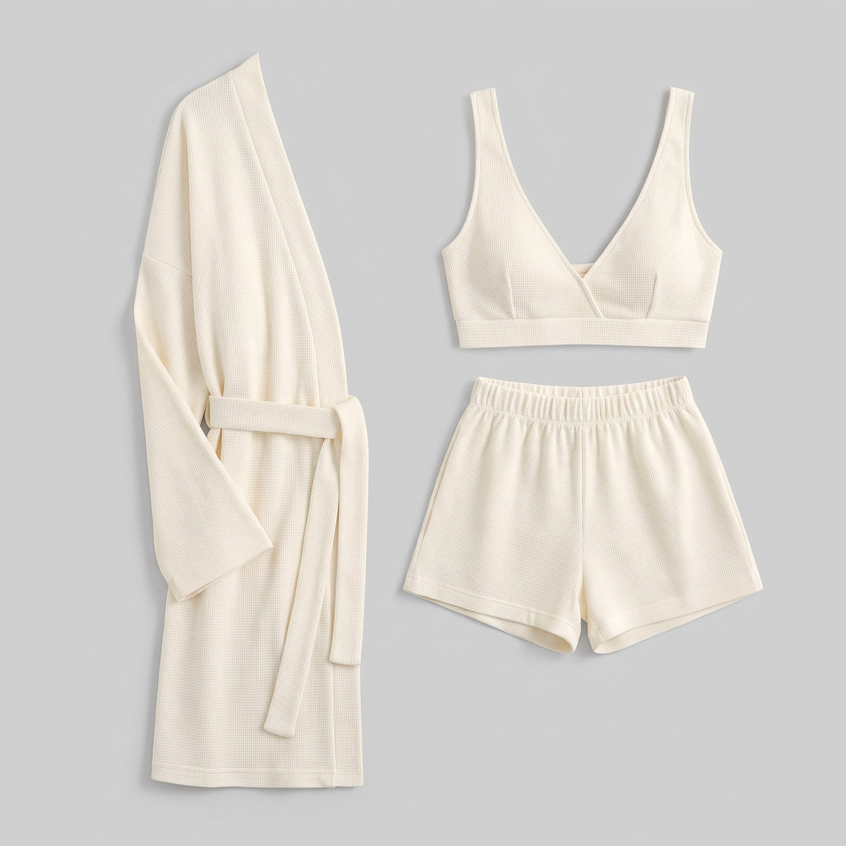Ninon waffle lounge set in cream, flat lay of the robe, shorts and bralette