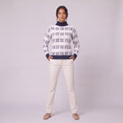 Nova snowflake knit sweater in navy blue, full-length view with hands in pockets