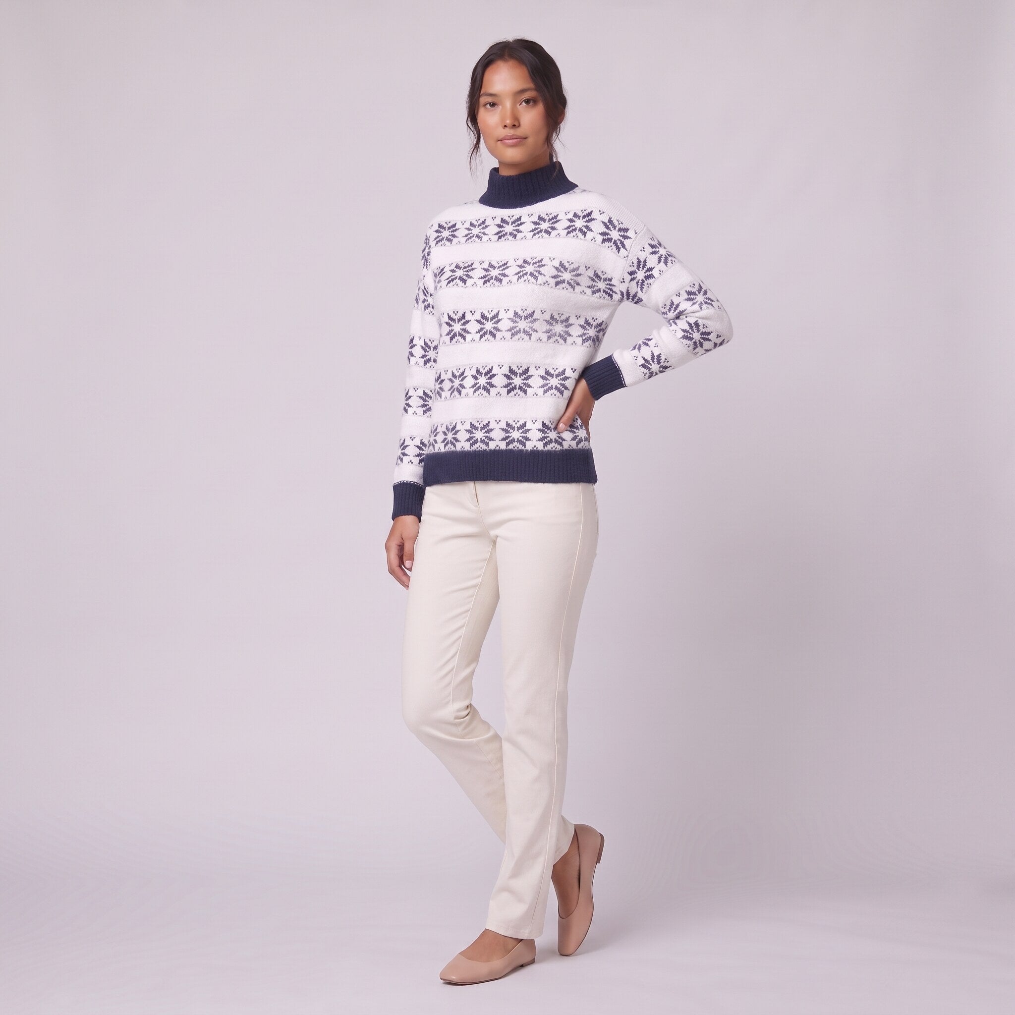 Nova snowflake knit sweater in navy blue, three-quarter view showing the fair-isle pattern