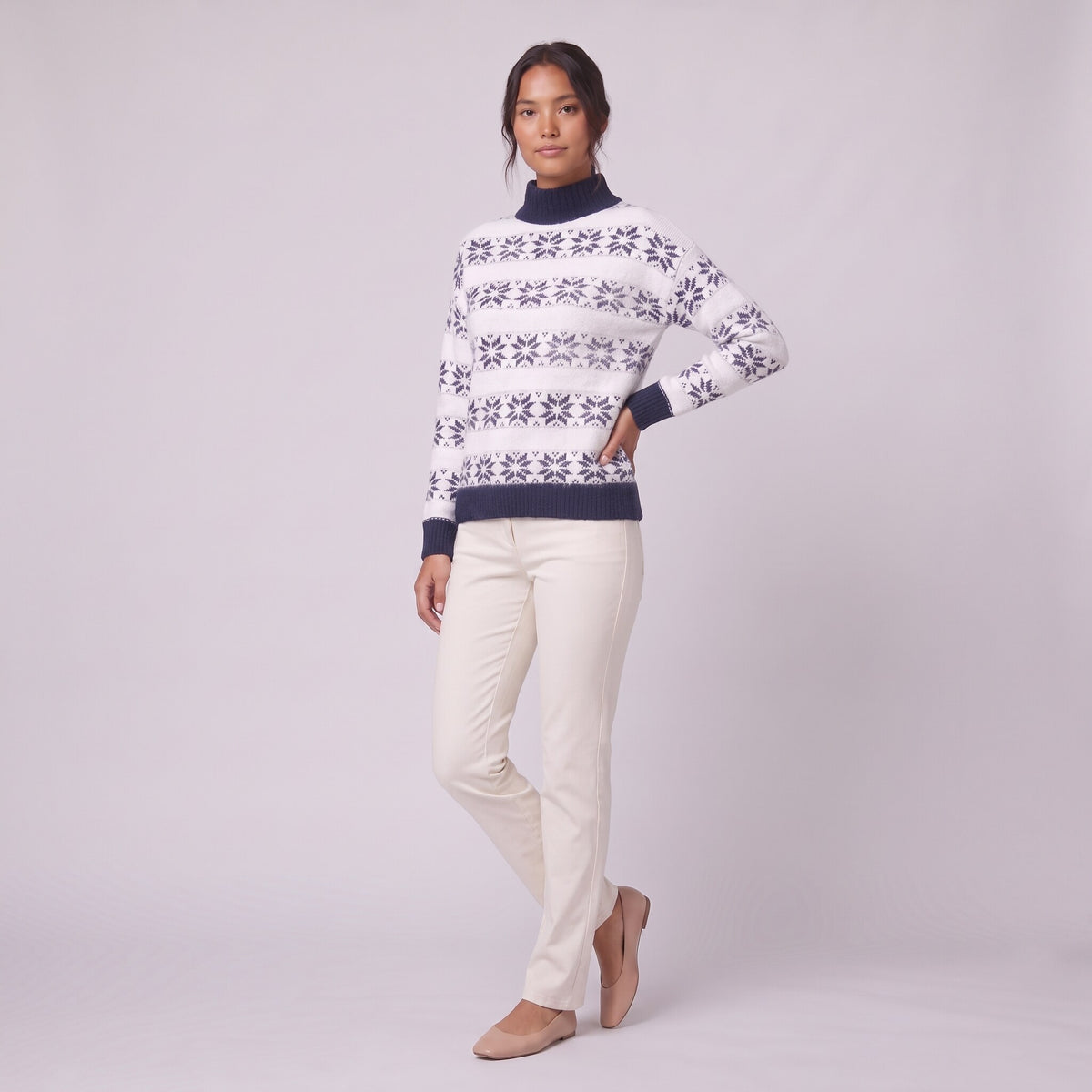 Nova snowflake knit sweater in navy blue, three-quarter view showing the fair-isle pattern