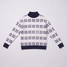 Nova snowflake knit sweater flat lay, full garment in navy blue Nordic pattern on light grey