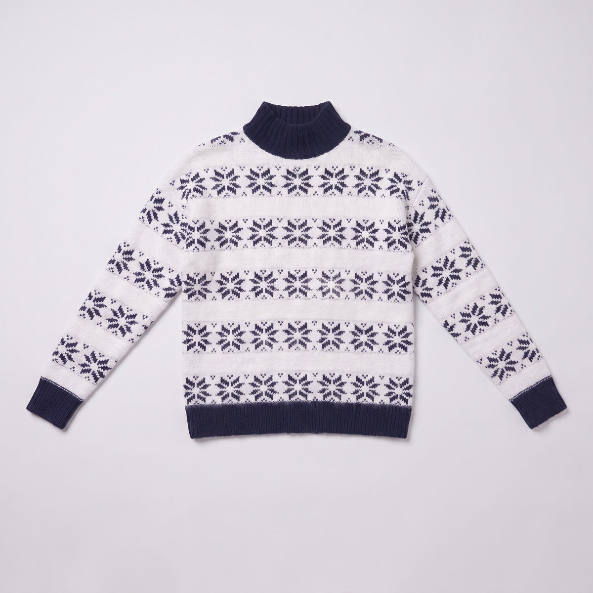 Nova snowflake knit sweater flat lay, full garment in navy blue Nordic pattern on light grey