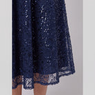 Close-up of the sequin embellishment and scalloped hem on the Novara dress