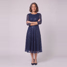 Novara navy sequin dress with arms crossed, standing view