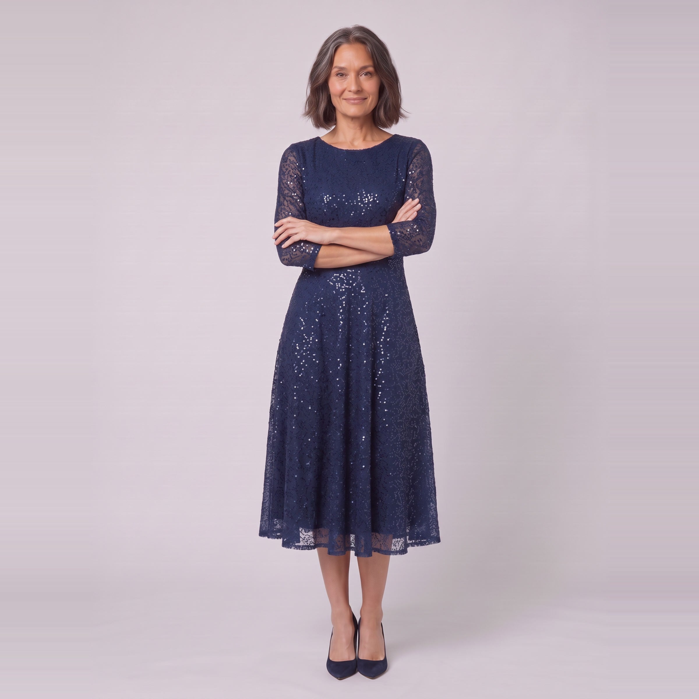 Novara navy sequin dress with arms crossed, standing view