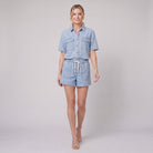 Sky blue pyjama set with a button-down top, walking view