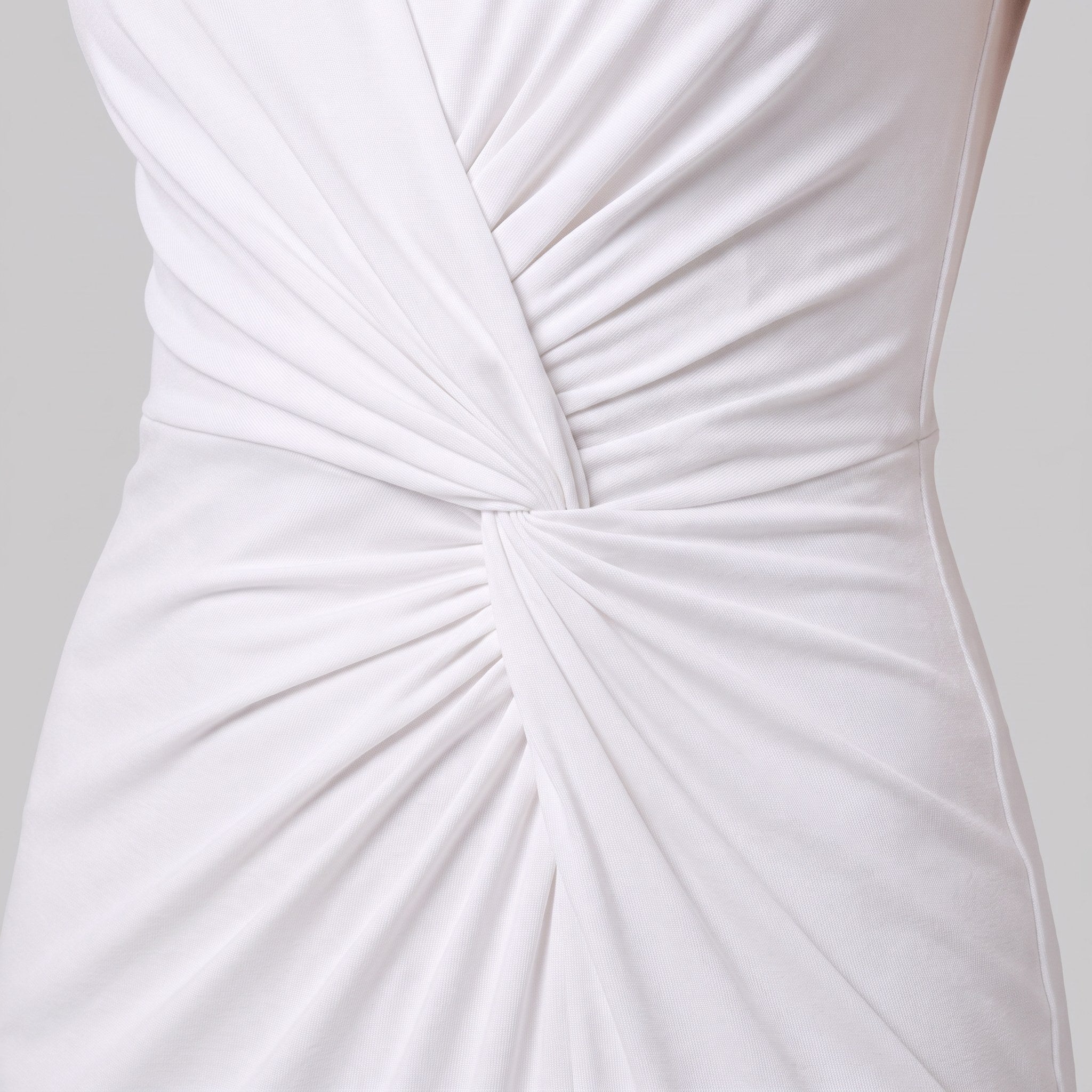 Close-up of the ruched twist knot and jersey fabric of the Perrine white maxi dress