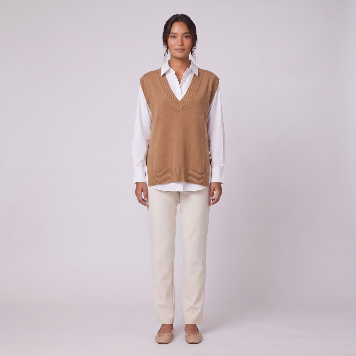 Roxane knit vest in camel brown, front view layered over a white shirt