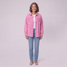 Saoirse distressed denim shacket in pink, oversized with raw hem, front view on model