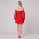 Scarlet Muse red mini dress seen from behind, showing the shirred back
