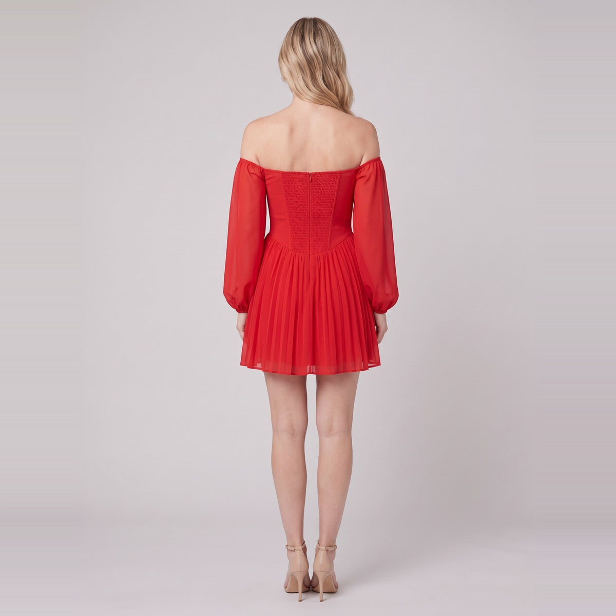 Scarlet Muse red mini dress seen from behind, showing the shirred back