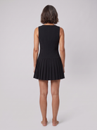 Black sleeveless mini dress with a pleated skirt and gold buttons, view 3