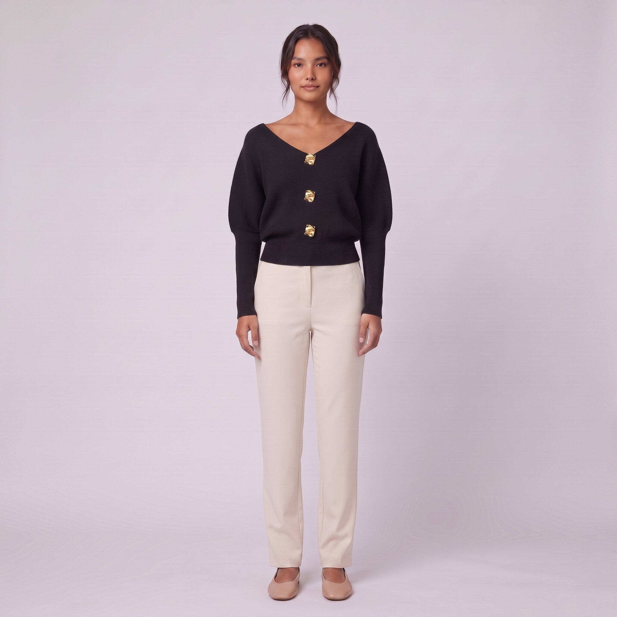 Solenne boat neck sweater with gold buttons in black, front view on model