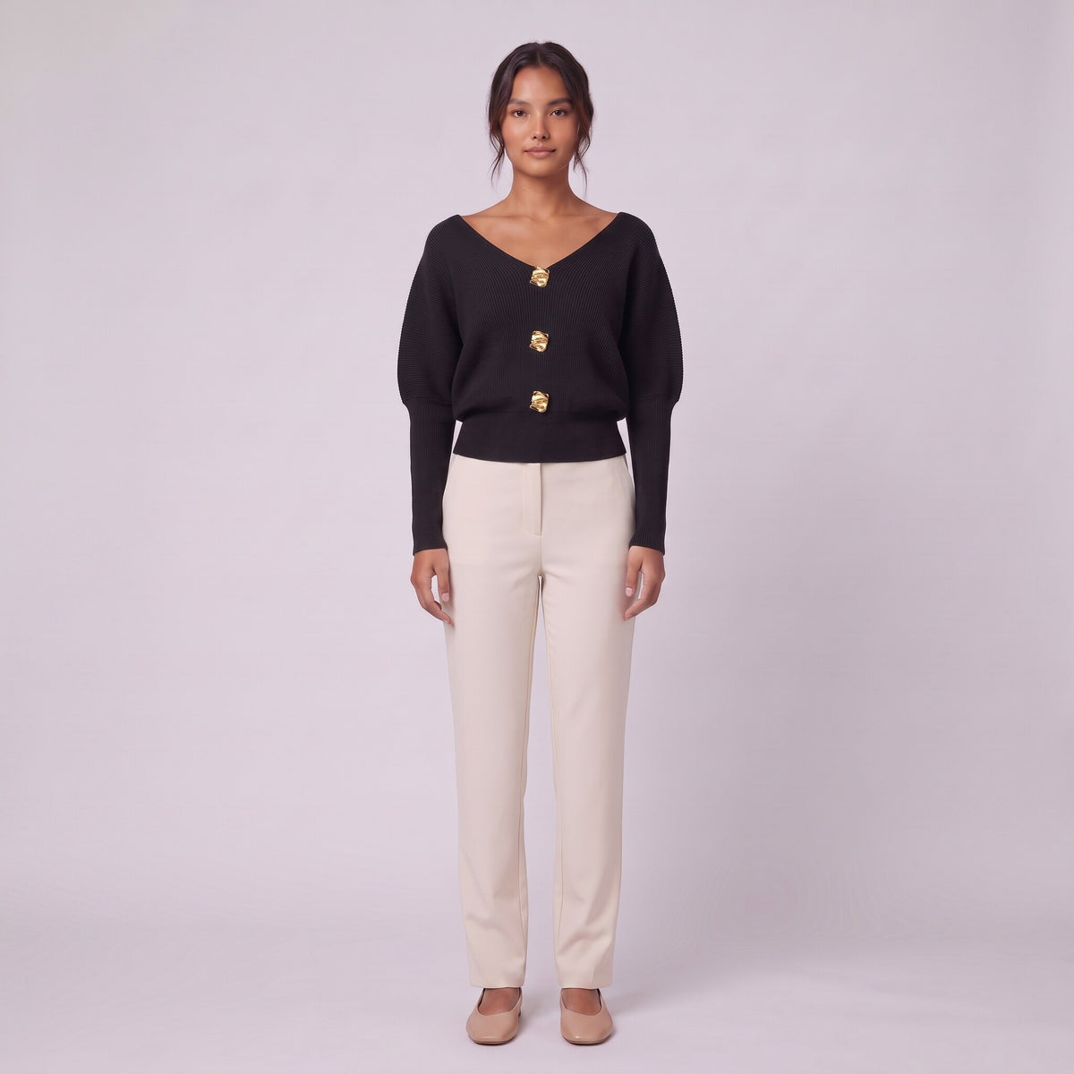 Solenne boat neck sweater with gold buttons in black, front view on model