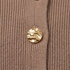 Solenne sweater fabric detail, taupe rib knit with ornate gold button
