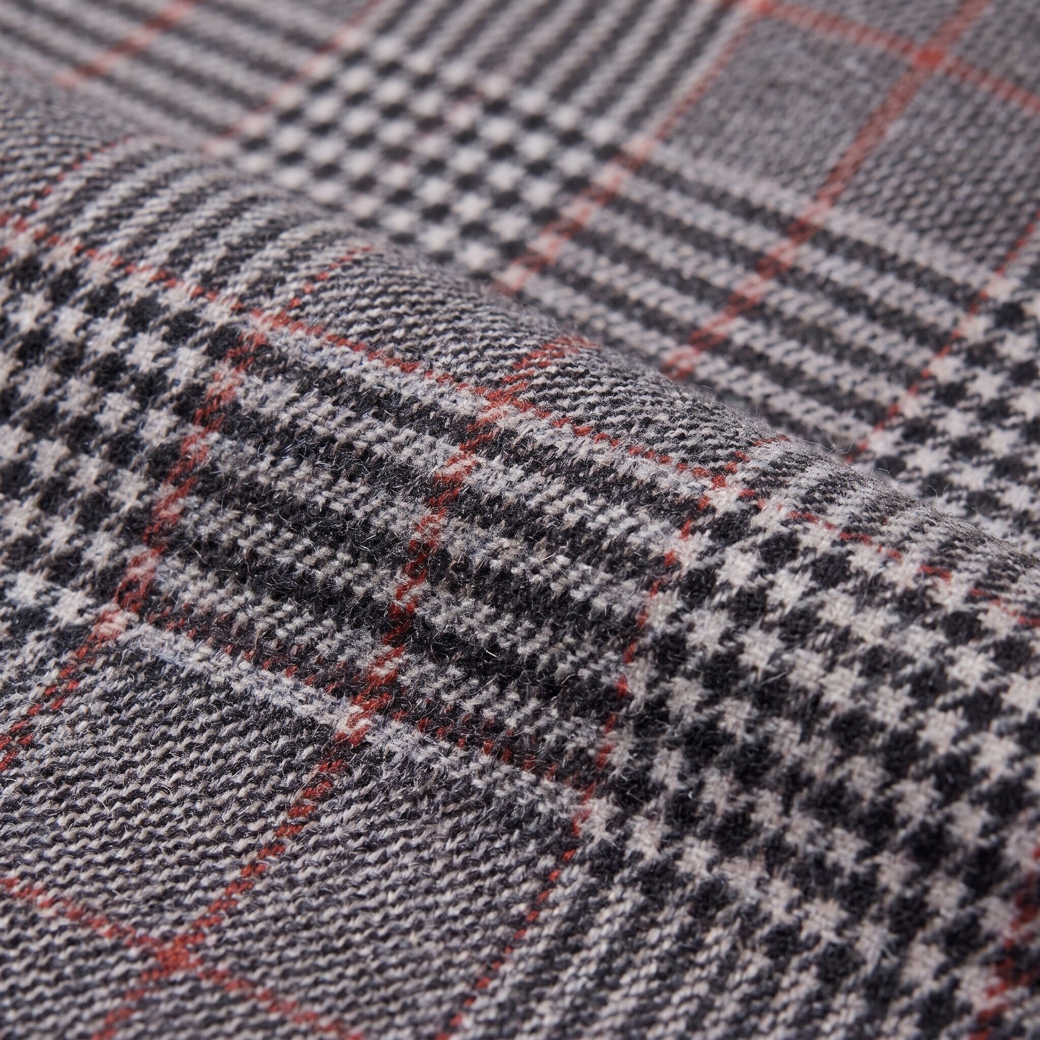 Sunniva check trousers fabric detail, Prince of Wales glen check weave with red overcheck close-up