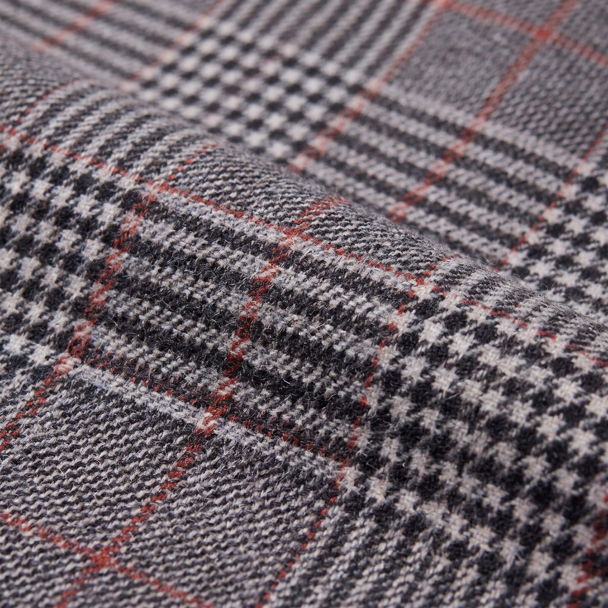 Sunniva check trousers fabric detail, Prince of Wales glen check weave with red overcheck close-up