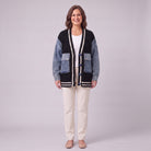 Tamsin denim sleeve cable knit cardigan in black, front view on model with cream trousers