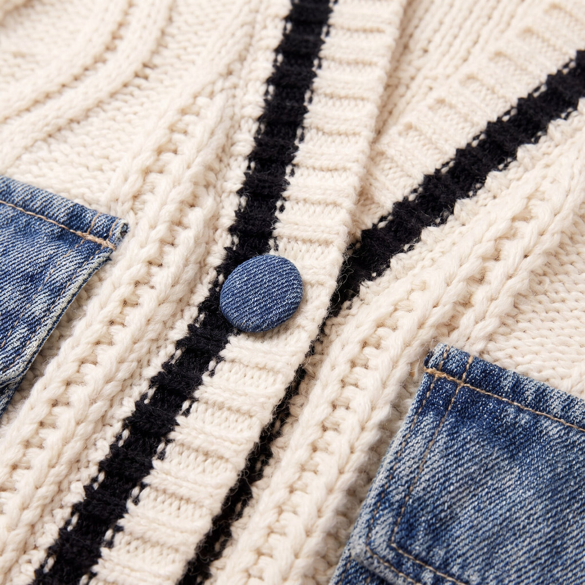 Tamsin cardigan fabric detail, cream cable knit with black stripe trim and denim panel