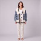 Tamsin denim sleeve cable knit cardigan in white, front view on model with cream trousers