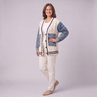 Tamsin denim sleeve cable knit cardigan in white, three quarter view showing denim patch pockets