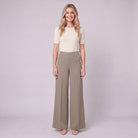 Valdis pleated wide leg trousers in taupe khaki with gold buttons, front view on model