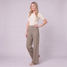 Valdis pleated wide leg trousers in taupe khaki, three-quarter view showing gold button detail