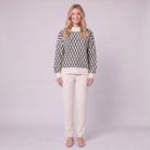 Zinnia lattice knit sweater in cream and black, front view on model