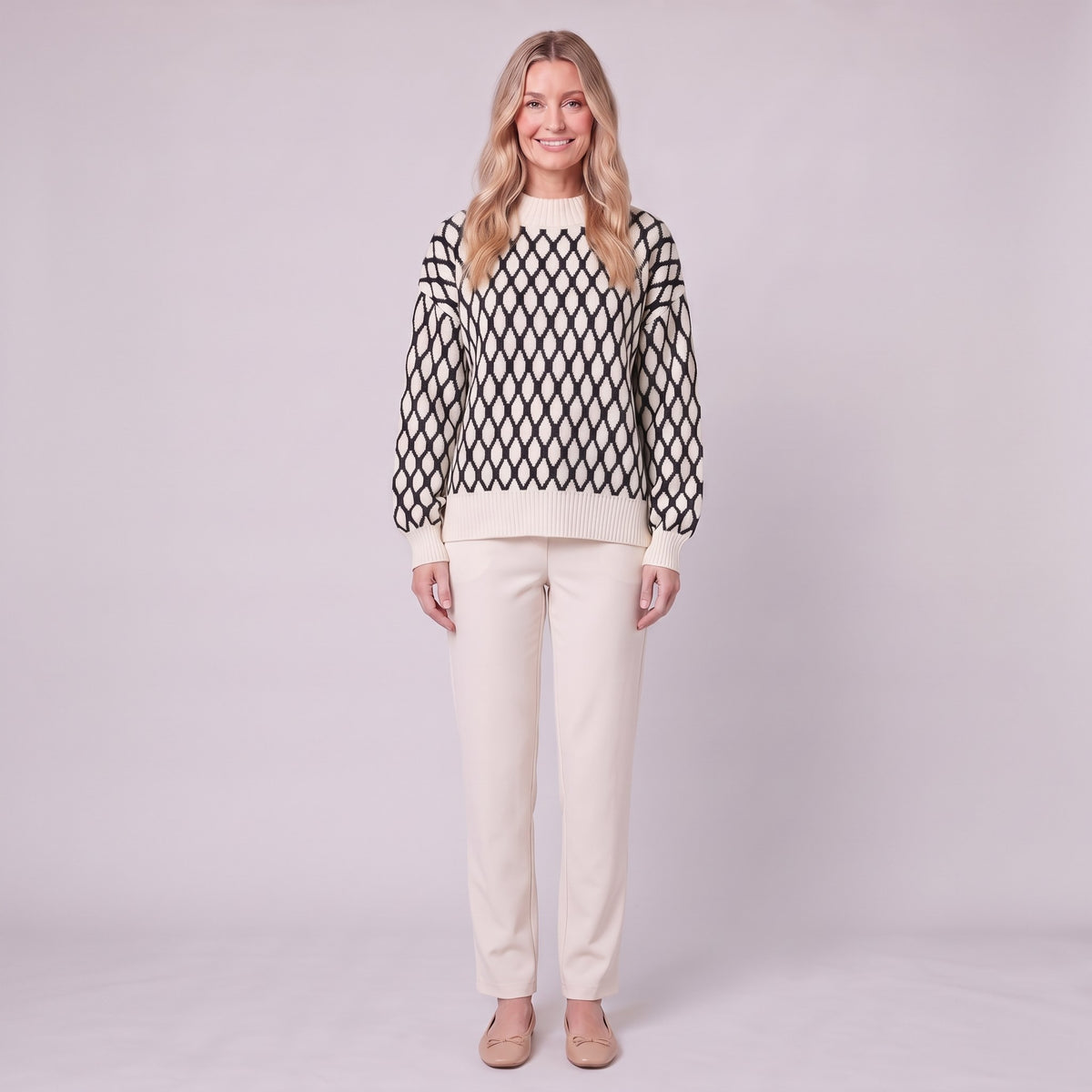 Zinnia lattice knit sweater in cream and black, front view on model