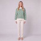 Zinnia lattice knit sweater in cream and emerald green, front view on model